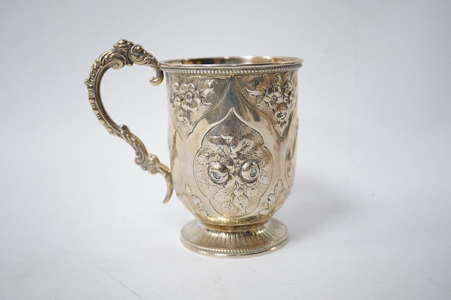 A Victorian embossed silver christening mug, George Adams, London, 1868, with later engraved monogram with date, 10.5cm, 4.5oz. Condition - fair to good